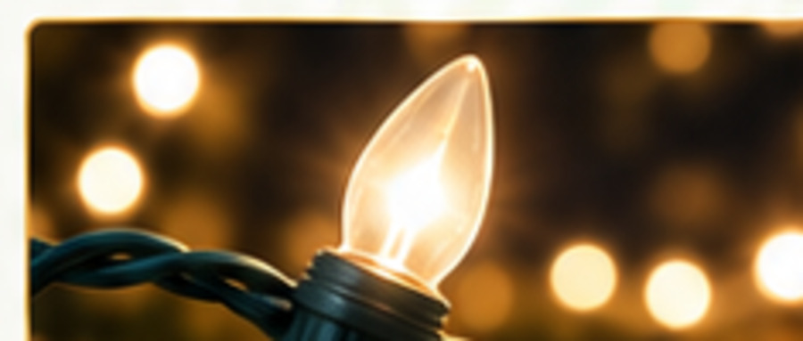 Close-up of a warm white C9 holiday bulb on green wire